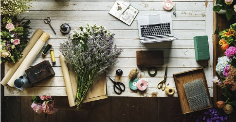 Creative workspace with laptop and flowers—professional email templates for small businesses